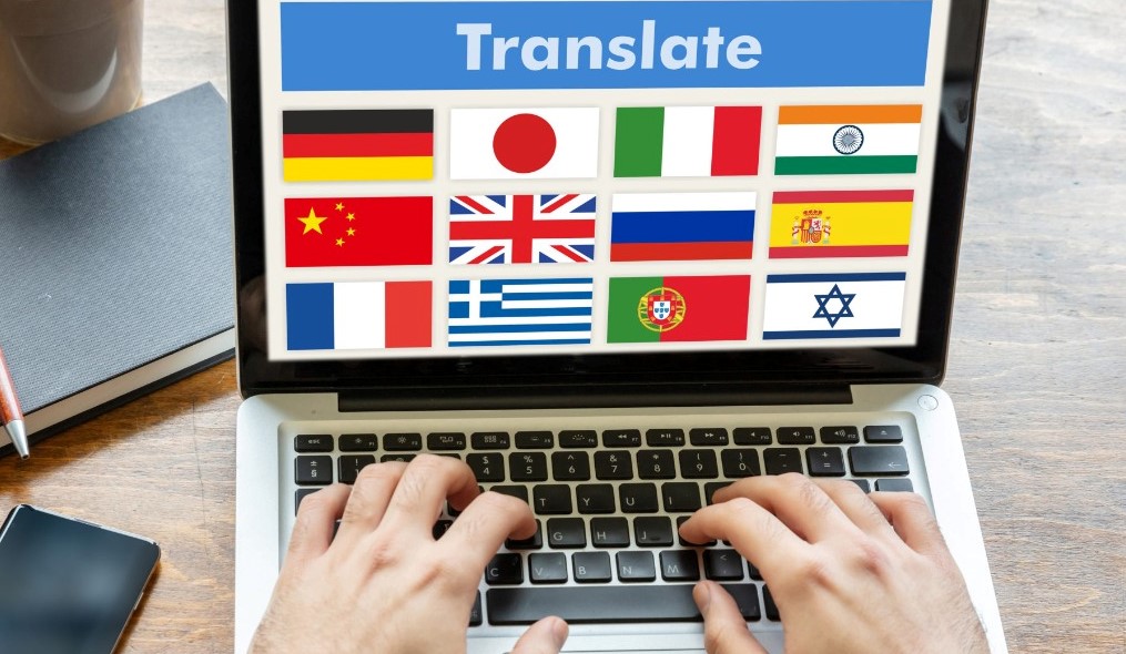 Laptop with word "TRANSLATE" on it...fingers typing below. (Image)