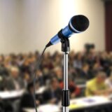 Public speaking (microphone w audience image)